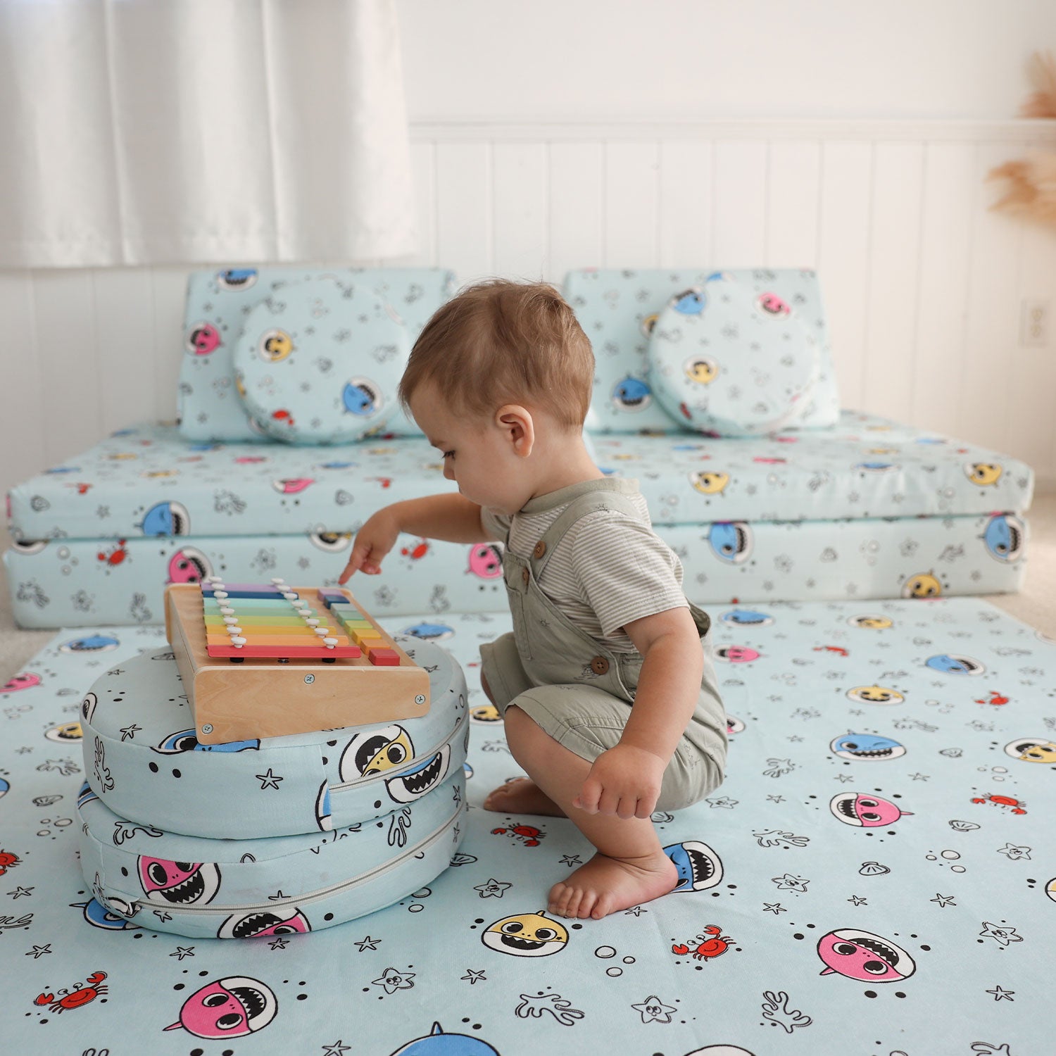 Little playing on the Baby Shark™ x Roo & You™ Play Mat with matching Stepping Stones.