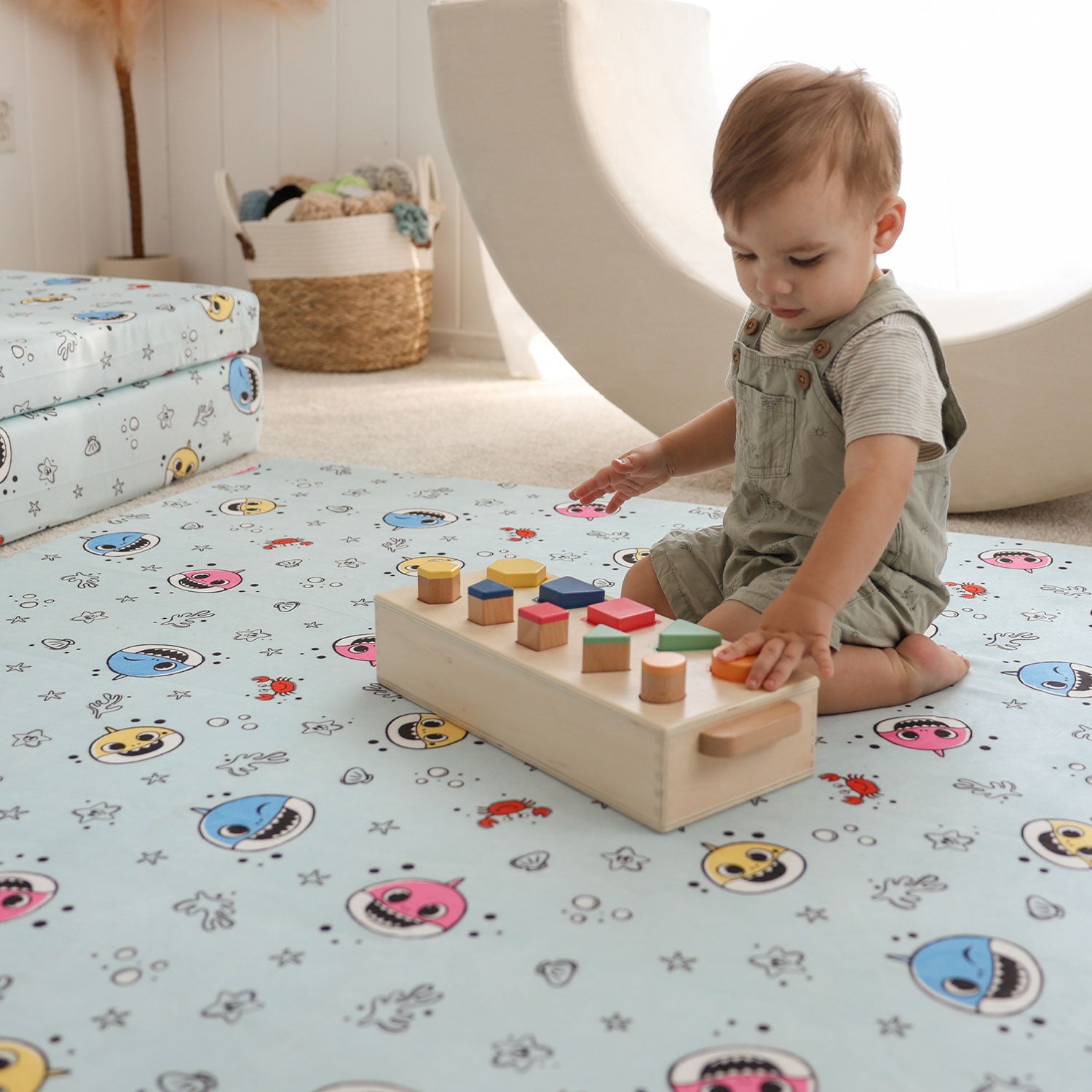 Little playing on the Baby Shark™ x Roo & You™ Play Mat with toys.