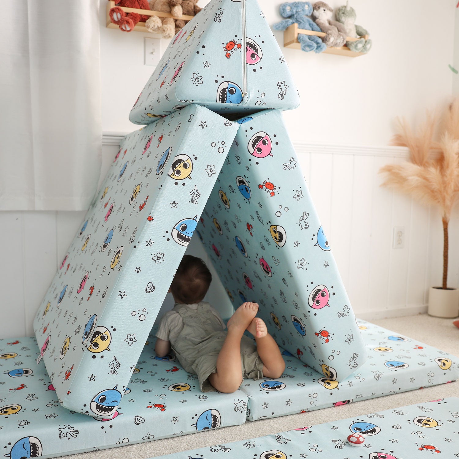 Toddler playing with Baby Shark™ x Roo & You™ Joey Play Couch covered in character print.