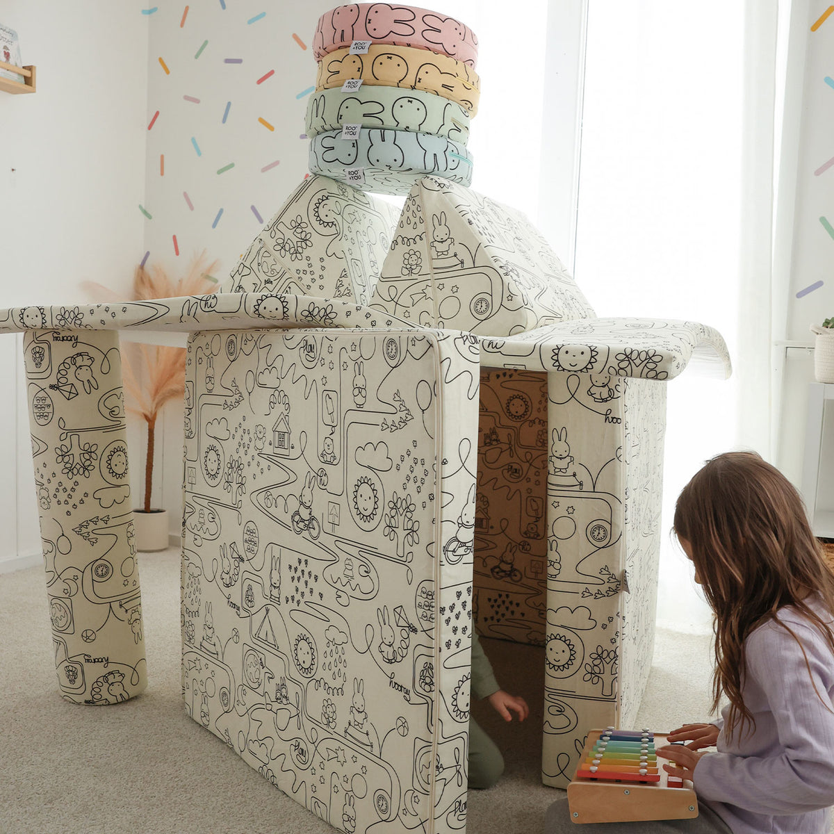 Child playing with  Miffy™ x Roo & You™ Joey Play Couch in bunny print.