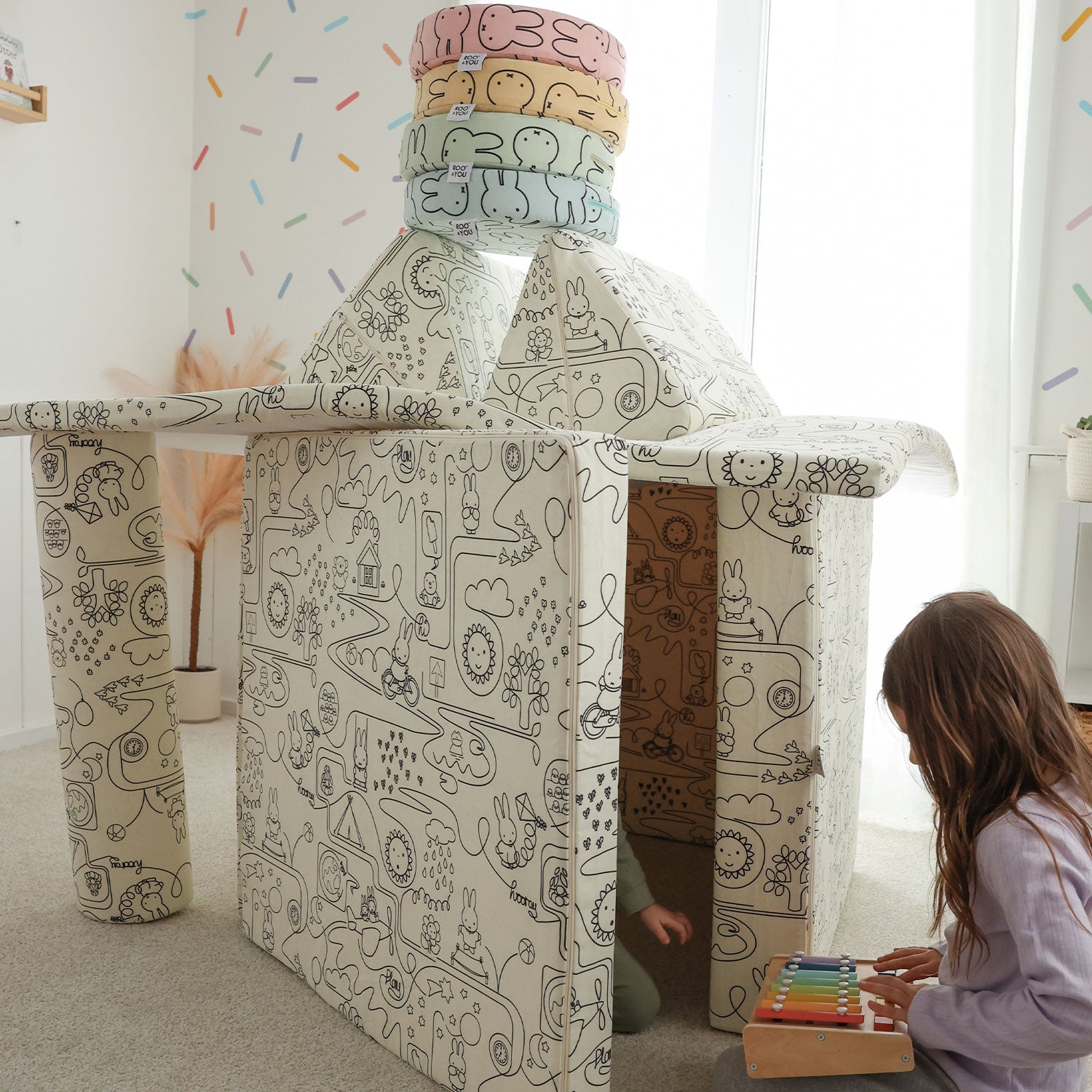 Child playing with  Miffy™ x Roo & You™ Joey Play Couch in bunny print.