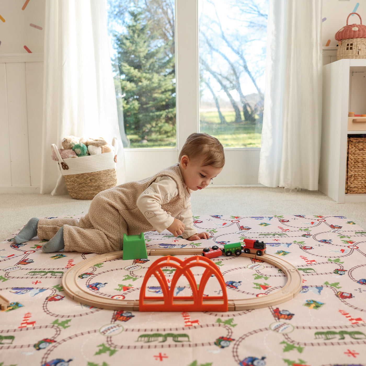 Child playing on Thomas & Friends play mat in playroom
