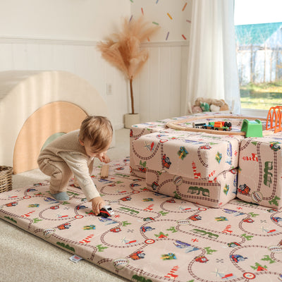 Child playing on Thomas & Friends play mat in playroom